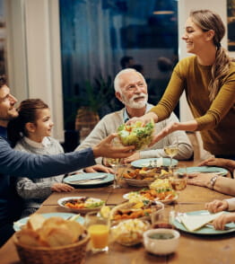 Refeição à mesa em ambiente feliz e em boas relações familiares  